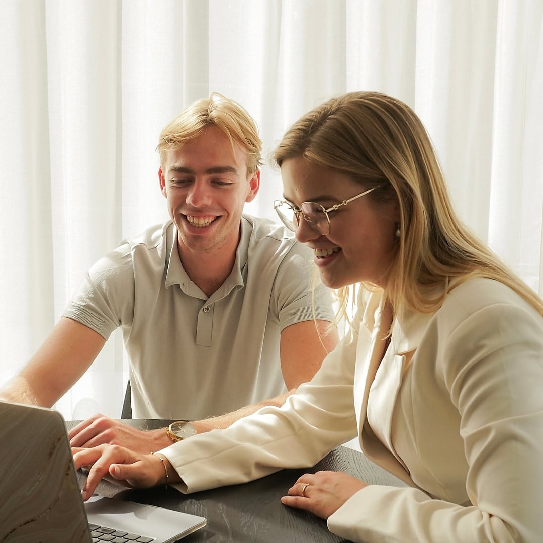 Esther en Jesse samen achter de laptop aan tafel